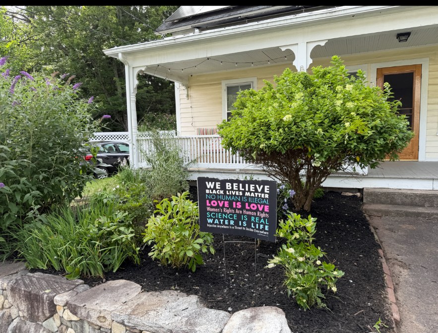 Front Porch Beds — Refreshed plantings with black mulch and fieldstone wall.